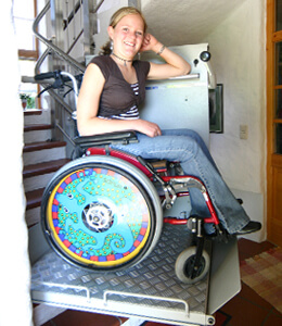 Frau im Rollstuhl auf Treppenlift